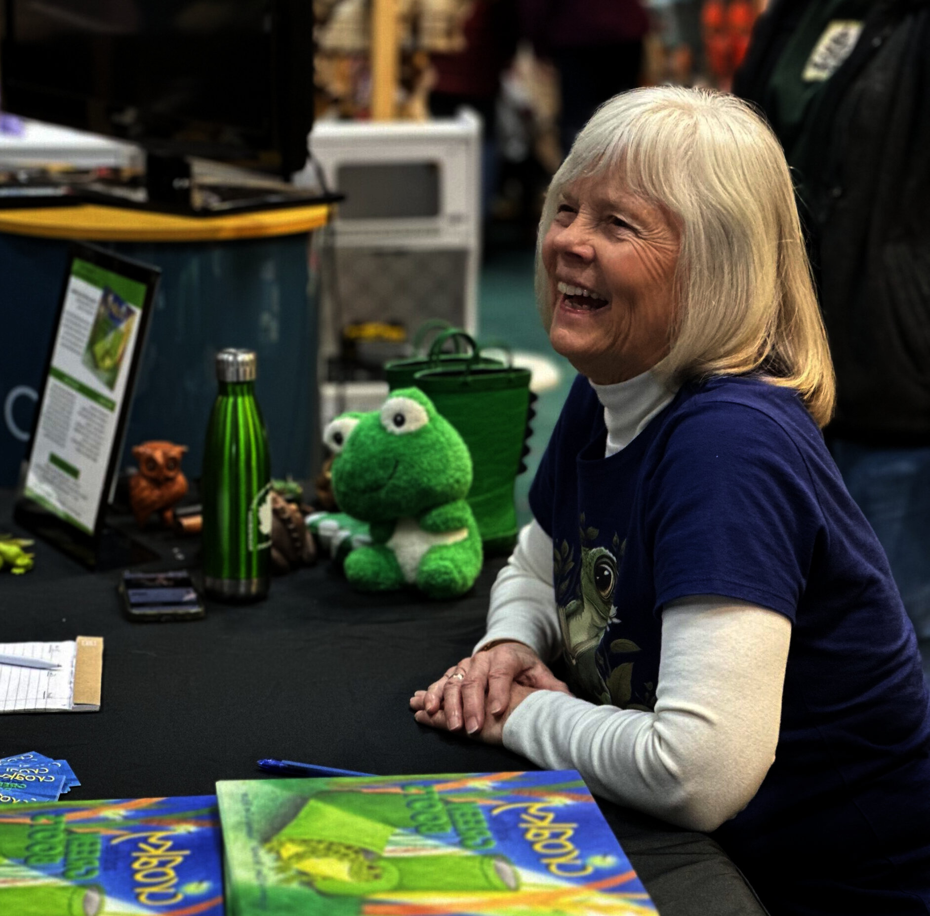 Author Lynne Reckman laughing during a book signing.
